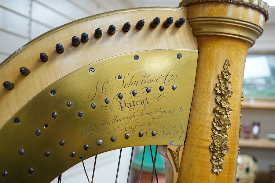 A Grecian satinwood seven pedal harp by J.C. Schwieso & Co., 19 Great Marlborough Street, Regent Street, London, numbered ‘824’, with brass makers plate and decorated with gilt mouldings, 173cm high